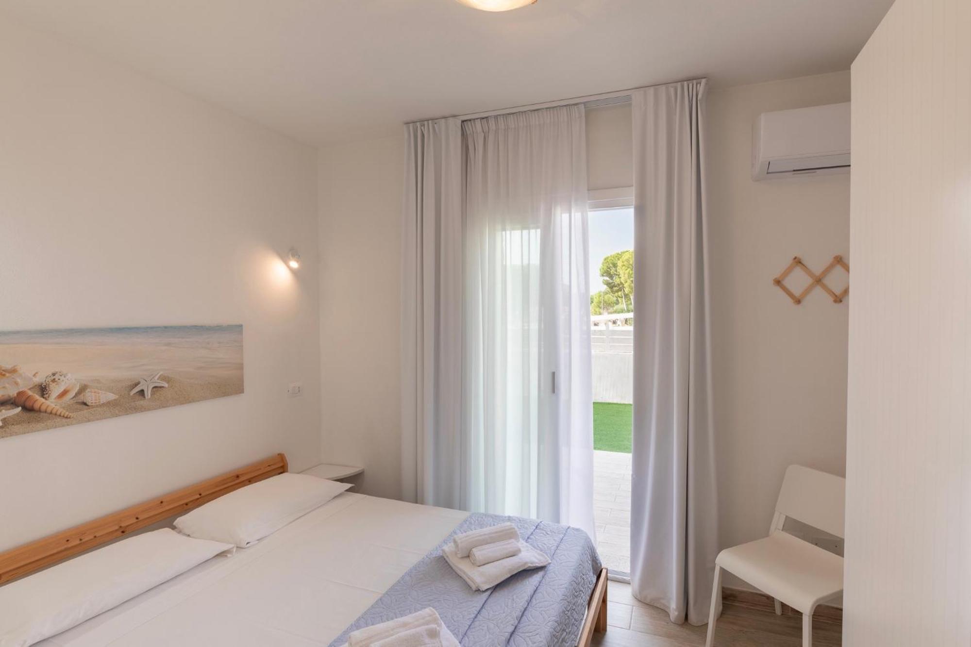 Case Vacanze "Bianco Mare" Porto Pino Szoba fotó